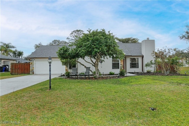 view of front of house featuring a garage and a front lawn