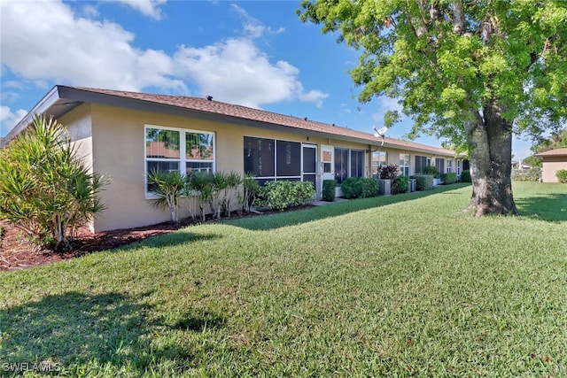 back of property featuring a lawn