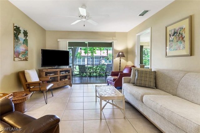 tiled living room with ceiling fan