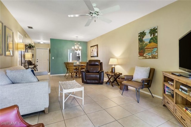 tiled living room with ceiling fan with notable chandelier