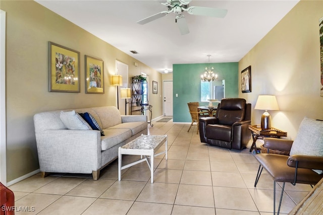 living room with light tile patterned flooring and ceiling fan with notable chandelier