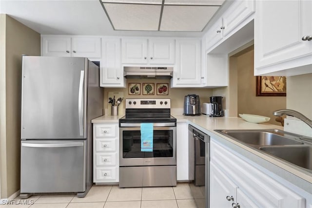 kitchen featuring sink, white cabinets, light tile patterned flooring, and appliances with stainless steel finishes