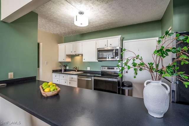 kitchen featuring white cabinetry, sink, a textured ceiling, and appliances with stainless steel finishes