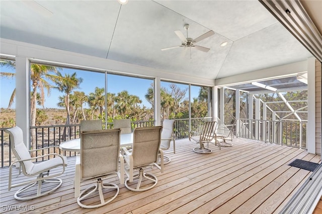 unfurnished sunroom with ceiling fan