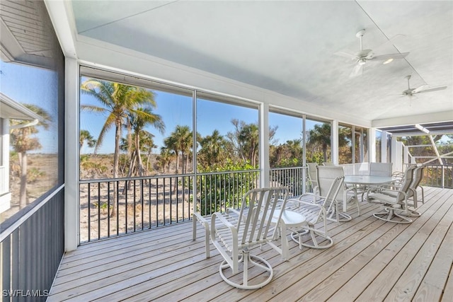 unfurnished sunroom with ceiling fan