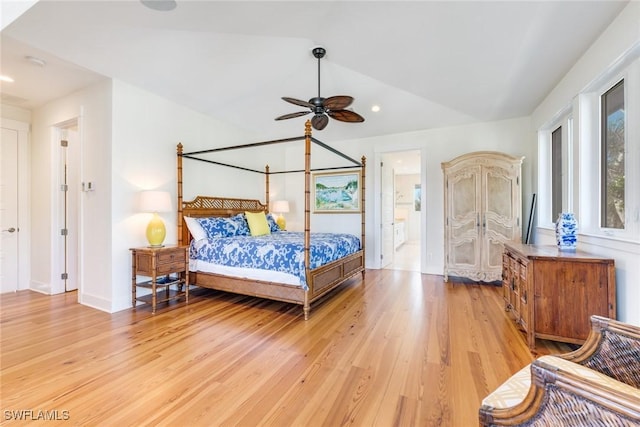 bedroom with ensuite bathroom, light hardwood / wood-style flooring, ceiling fan, and lofted ceiling