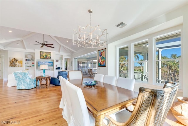 dining room with vaulted ceiling with beams, light hardwood / wood-style floors, ceiling fan with notable chandelier, and a wealth of natural light