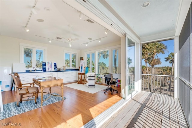 sunroom with french doors, ceiling fan, sink, and track lighting