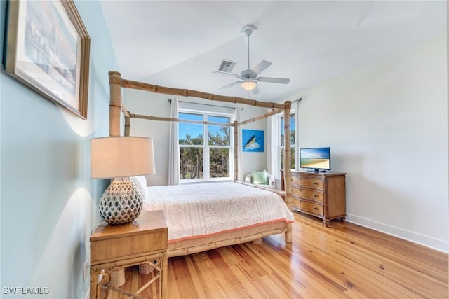 bedroom featuring ceiling fan, hardwood / wood-style floors, and vaulted ceiling