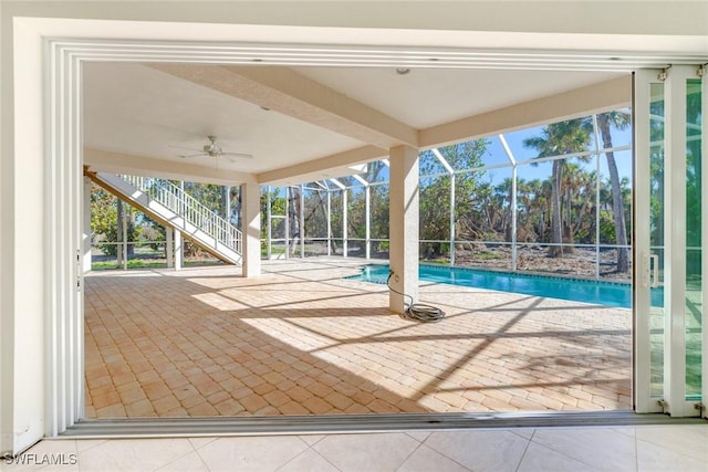 view of patio / terrace featuring glass enclosure and ceiling fan