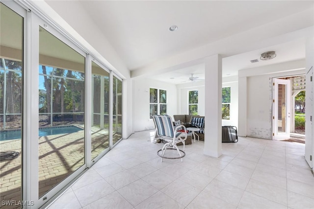 sunroom / solarium featuring plenty of natural light and ceiling fan