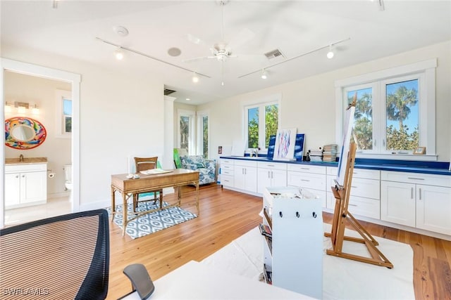 kitchen with white cabinetry, ceiling fan, light hardwood / wood-style floors, and rail lighting