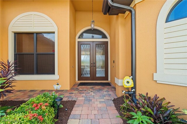 2108 SW 38th Ter, Cape Coral, FL 33914 - doorway to property featuring french doors and stucco siding