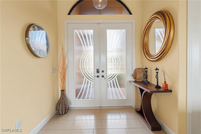 entryway featuring light tile patterned flooring, a healthy amount of sunlight, and french doors