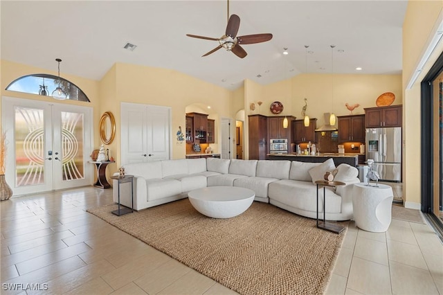 living room with ceiling fan, french doors, and high vaulted ceiling