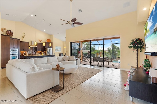 living room with high vaulted ceiling and ceiling fan