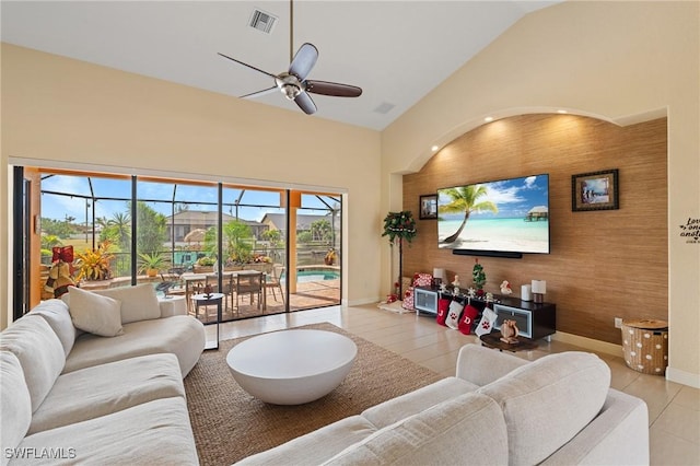 living room featuring ceiling fan and high vaulted ceiling