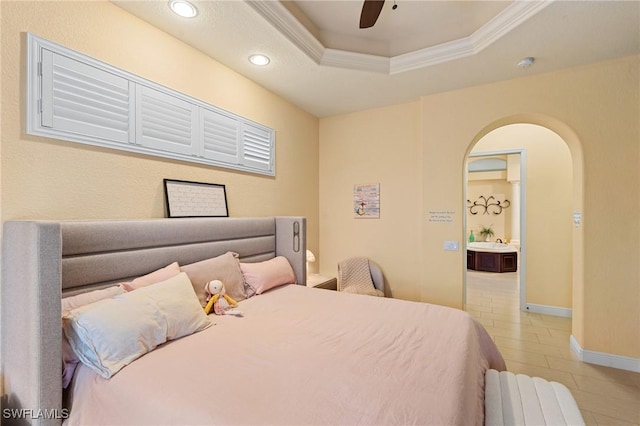 bedroom with ceiling fan, a raised ceiling, and ornamental molding