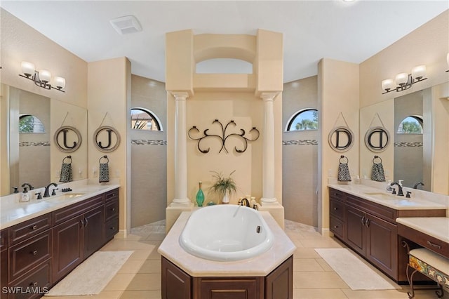 bathroom featuring decorative columns, independent shower and bath, tile patterned floors, and vanity