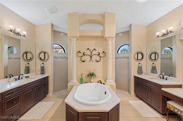2108 SW 38th Ter, Cape Coral, FL 33914 - bathroom with ornate columns, plenty of natural light, and a garden tub