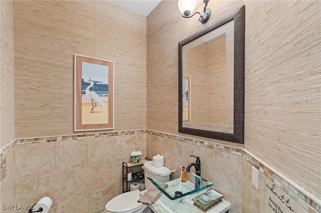 2108 SW 38th Ter, Cape Coral, FL 33914 - bathroom with tile walls, toilet, and wainscoting