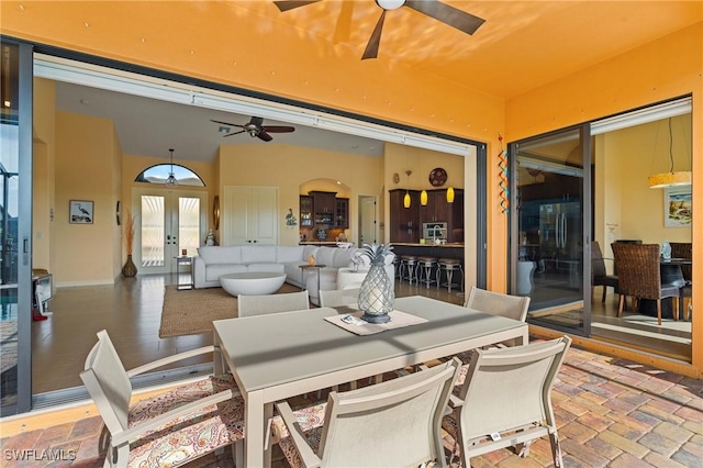 dining area featuring ceiling fan and french doors