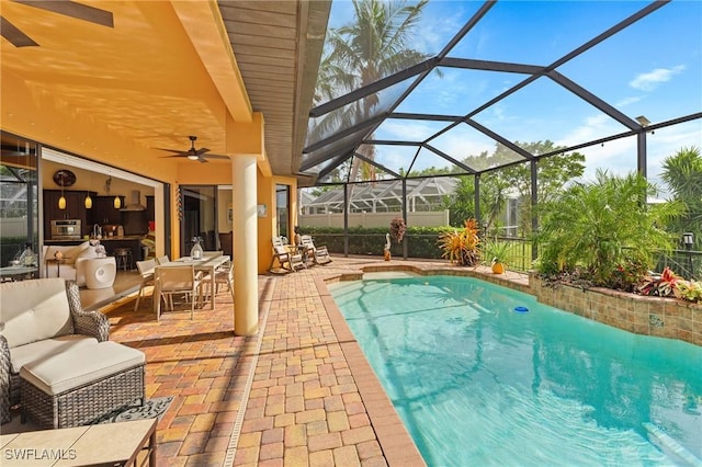 view of swimming pool featuring a patio, glass enclosure, ceiling fan, and outdoor lounge area