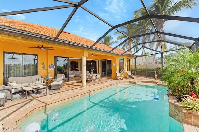 view of pool with an outdoor living space, a lanai, a patio, and ceiling fan