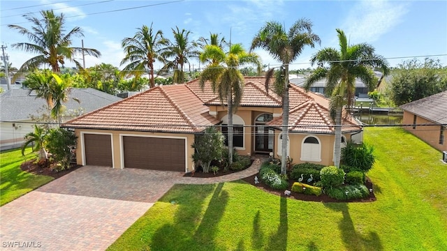 2108 SW 38th Ter, Cape Coral, FL 33914 - mediterranean / spanish home featuring stucco siding, decorative driveway, an attached garage, a tile roof, and a front yard