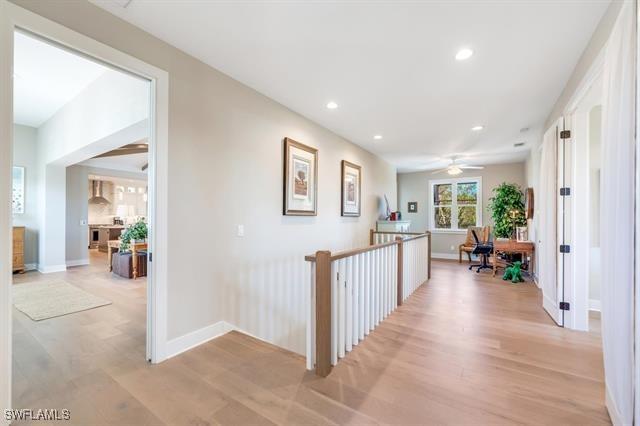 corridor with light hardwood / wood-style floors