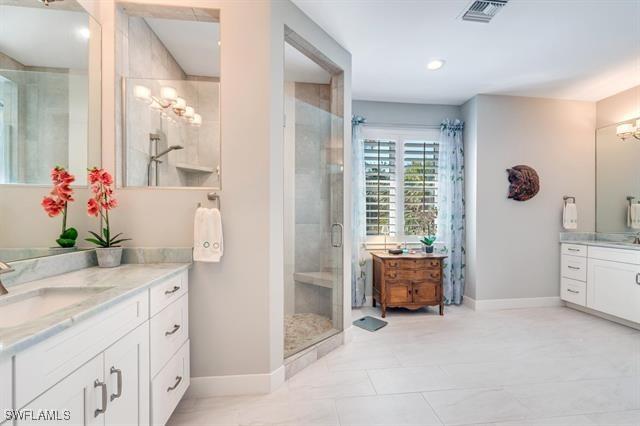 bathroom featuring vanity and a shower with shower door