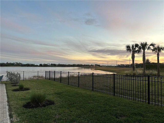 yard at dusk with a water view