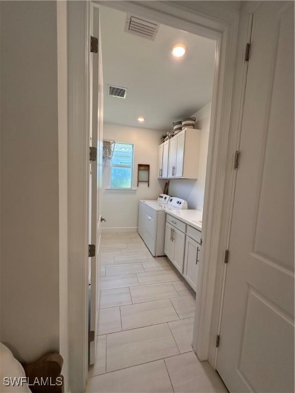 bathroom featuring tile patterned floors and washing machine and dryer