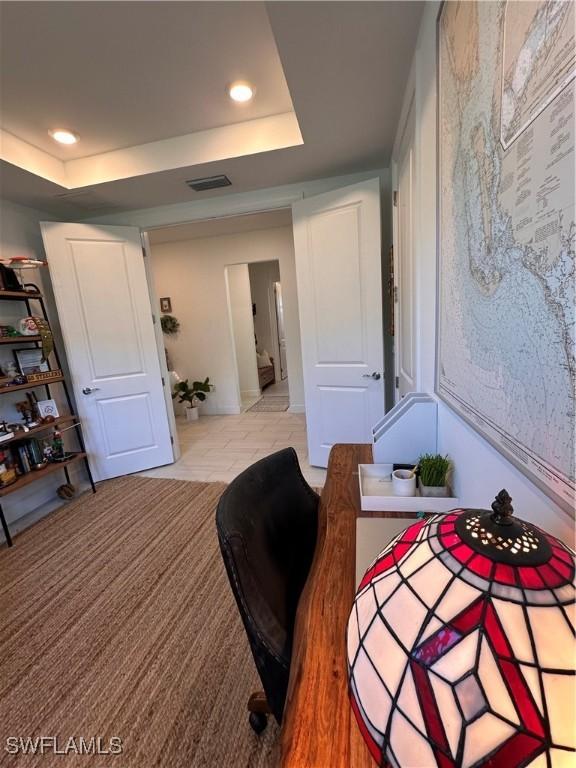 bedroom featuring a raised ceiling