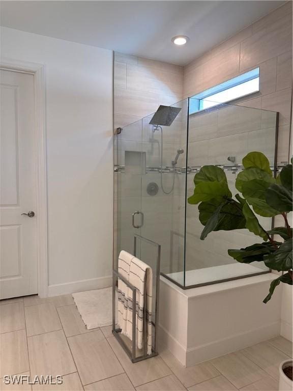 bathroom with a shower with door