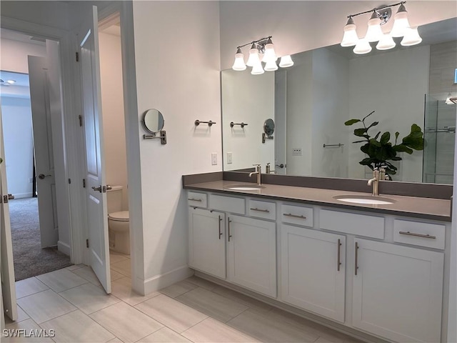 bathroom with tile patterned flooring, vanity, and toilet