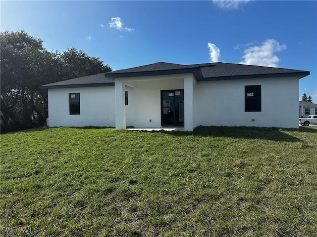 rear view of house with a lawn