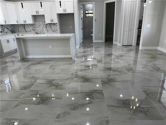 kitchen featuring white cabinets and a kitchen island