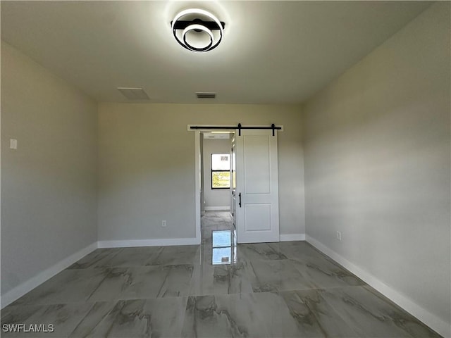 empty room featuring a barn door