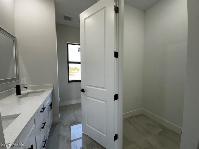 bathroom with vanity and toilet