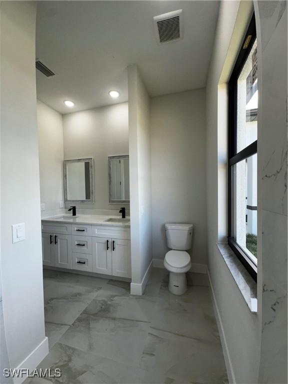 bathroom with vanity and toilet