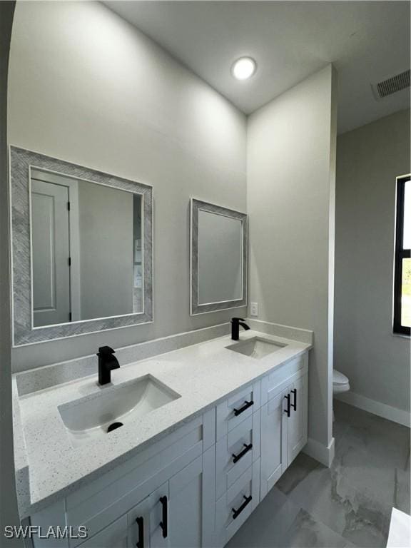 bathroom with vanity and toilet