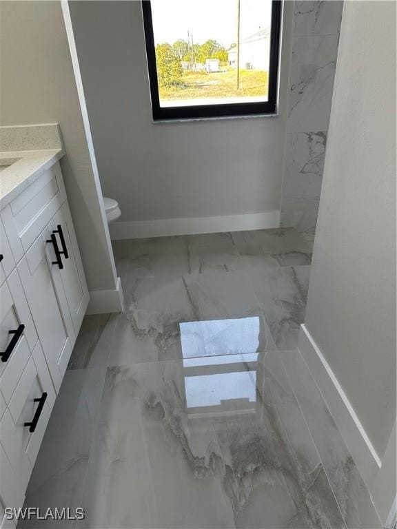 bathroom featuring vanity and toilet