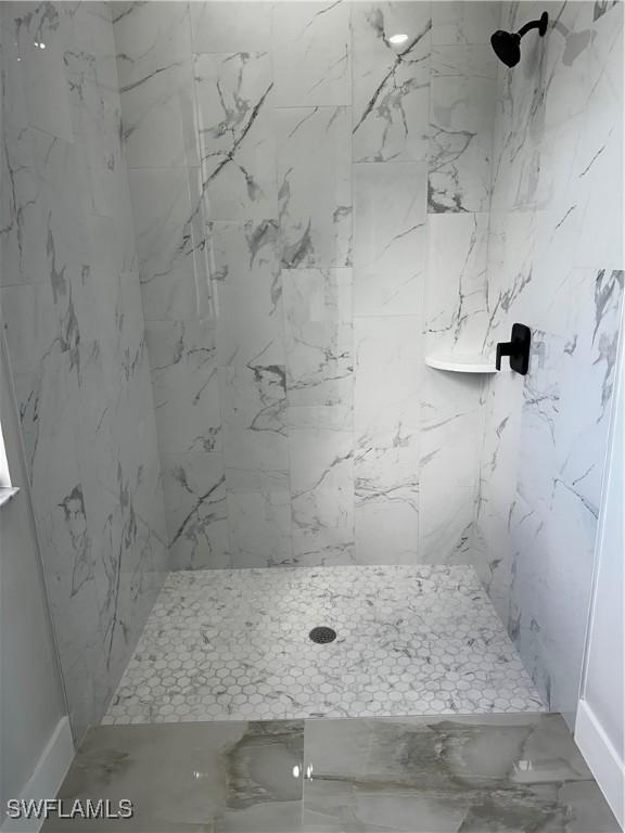 bathroom with tiled shower