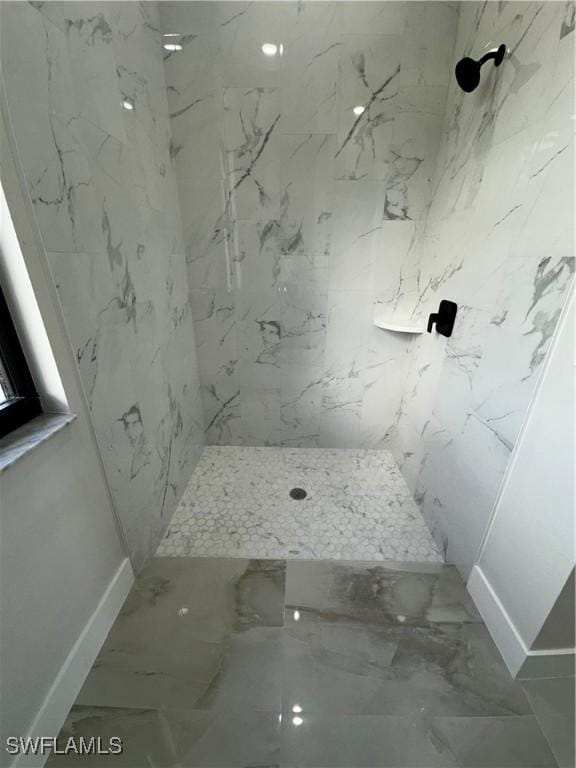 bathroom featuring a tile shower