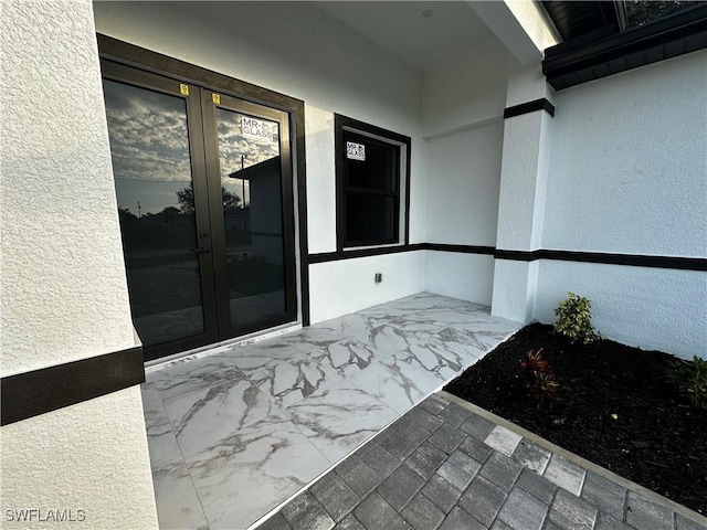 property entrance featuring french doors