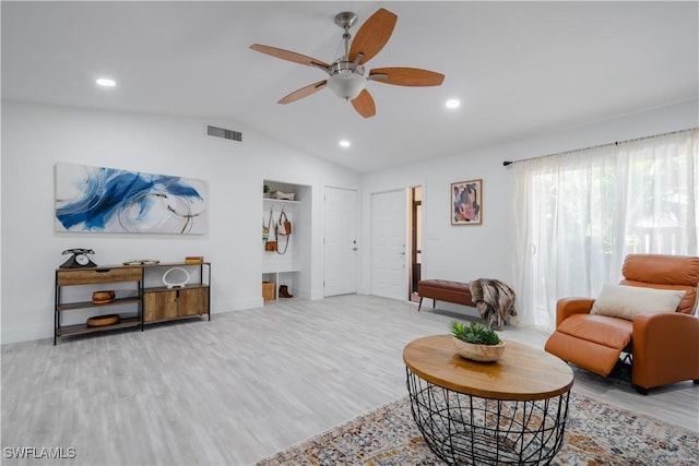 living room with light wood-type flooring, ceiling fan, and lofted ceiling