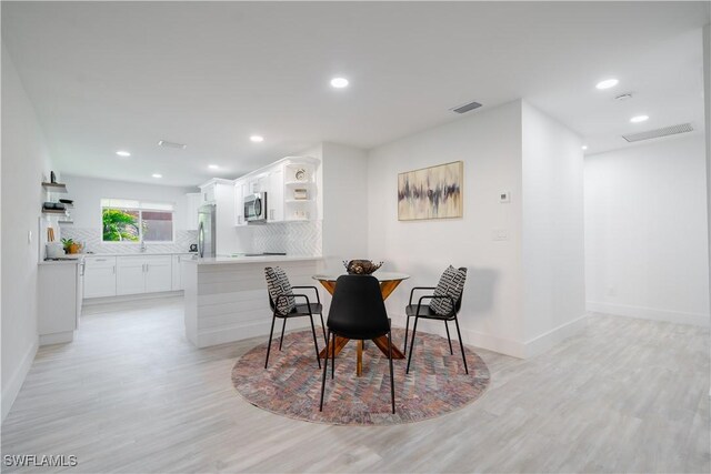 dining room with light wood-type flooring