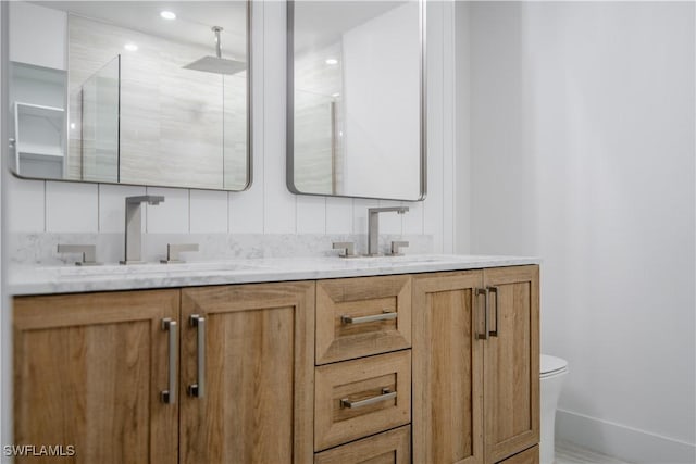 bathroom featuring vanity, toilet, and a shower with shower door