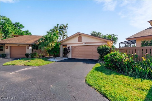 view of front of home featuring a garage and a front yard